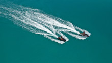 Aerial Drone Top Down Photo Of 2 Men Operating Jet Ski Watercraft Cruising In High Speed In Tropical Exotic Lake