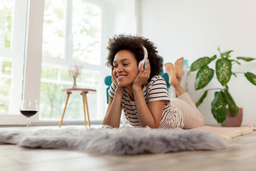 Wall Mural - Woman listening to the music and relaxing at home