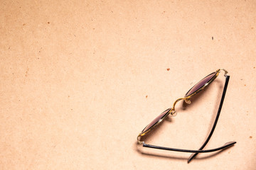 Sunglasses on wooden table .