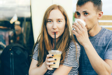 Close Up Portrait Of A Caucasian Girl With A Guy Drinking Coffee. Relations Of Modern Millennials, Coffeemania And Urban Style.