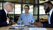 © motortion - Upset business woman looking at colleagues arguing at office meeting, stress
