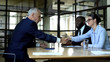 © motortion - Business partners shaking hands meeting room, project negotiation, cooperation