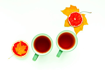 Two cups with tea on white isolated background..Autumn decor