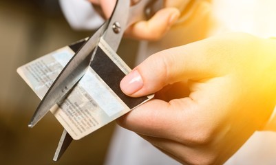 Cutting up credit card with scissors