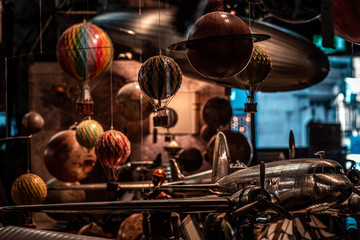 Lots of old toys together with small hot air balloons hanging, planes and airships softly illuminated. Concept of nostalgic memories.