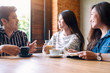 © Farknot Architect - A group of people enjoyed talking, reading and drinking coffee together in cafe