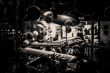 Lots of old toys together with small hot air balloons hanging, planes and airships softly illuminated in black and white. Concept of nostalgic memories.