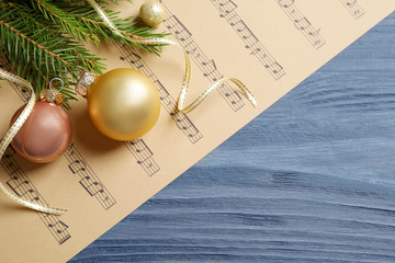 Sticker - Flat lay composition with Christmas decorations and music sheets on blue wooden table. Space for text