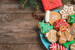 Flat lay composition with tasty homemade Christmas cookies on wooden table. Space for text