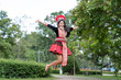 © somchairakin - Hmong girl with traditional clothes costumes jumping in the garden