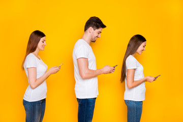 Poster - Profile side view portrait of three nice attractive lovely focused cheerful cheery person using wi-fi connection speed browsing web isolated over bright vivid shine yellow background