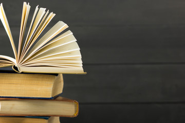 Open book, hardback books on wooden table. Back to school. Copy space