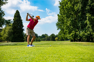 Wall Mural - Close up Golfer is driving golf ball to green course