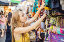 Woman Traveler Choose Souvenirs In The Market At Ubud In Bali, Indonesia