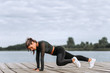 © bnenin - Fitness woman doing body core exercise outdoors.