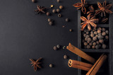 Fototapeta Desenie - allspice, cinnamon, anise stars on a dark background, aromatic spices