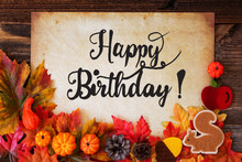 Old Paper With Text Happy Birthday. Colorful Autumn Decoration Like Pumpkin And Leaves