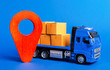 A blue truck loaded with boxes and a red pointer location. Services transportation of goods, products, logistics and infrastructure. Transportation company. Location of carriers. Package tracking