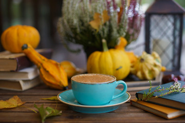 Wall Mural - Cup of coffee with cinnamon on an open table