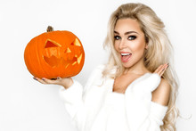 Surprised Woman With Beautiful Face And Blond Hair Holding Pumpkin In Studio On White Background. Halloween Concept - Image