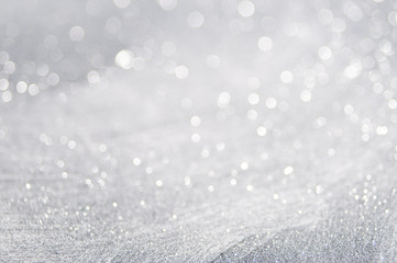 abstract of bright and sparkling bokeh background. silver and diamond dust bokeh blurred lighting fr