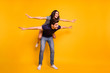© deagreez - Full length body size photo of cheerful friendly kind nice couple of two people wearing jeans denim playing airplane with each other while isolated with yellow background