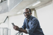 © ReeldealHD images - Portrait of african american male executive holding a smartphone