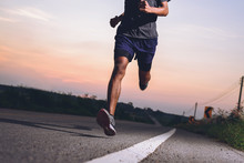 Athlete Runner Feet Running On Road, Jogging Concept At Outdoors. Man Running For Exercise.