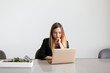 © Deidre - Pretty young girl working at computer in office, white background, copy space