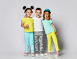 © FAB.1 - Triplets, brother and sisters. laughing and screaming loud have fun in the studio. full body shot of three children in bright clothes, two girls and one boy.