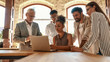 © Kostiantyn - Successful team. Multicultural team looking at the laptop and discussing something while working together in the modern office