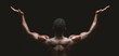 Rear view of african bodybuilder raising his palms up