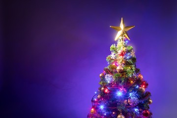 Christmas tree with festive lights, purple background