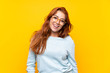 © luismolinero - Teenager redhead girl over isolated yellow background with glasses and happy