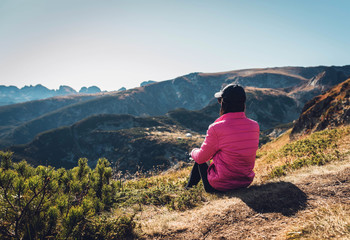 young woman walking in the mountains