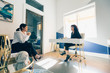 © Gerald Carter/Creative Flame - Low angle view of two young businesswomen relaxing and talking