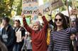 © Halfpoint - People with placards and posters on global strike for climate change.