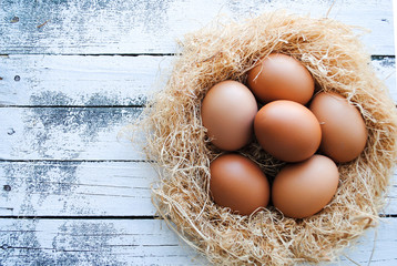 Wall Mural - Nest with brown chicken eggs.