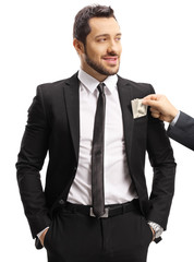 Sticker - Male hand putting money in a businessman's suit pocket