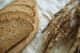 Fototapeta Kuchnia - Sliced bread on a wooden board