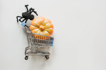 Wall Mural - Halloween decorations with black spiders on orange and grey. Flat lay, top view, copy space.