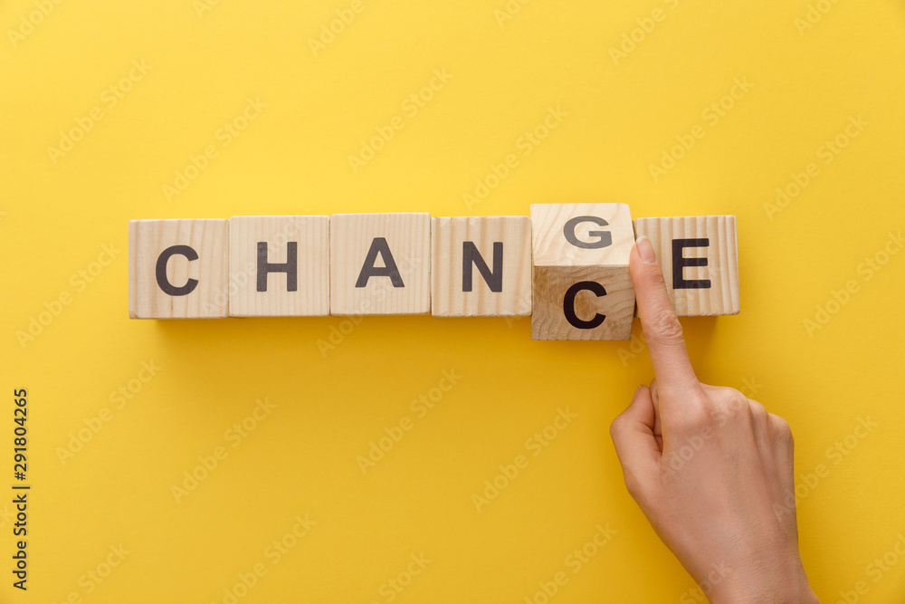 cropped view of woman switching wooden cube from word change to chance on yellow background - obrazy, fototapety, plakaty 
