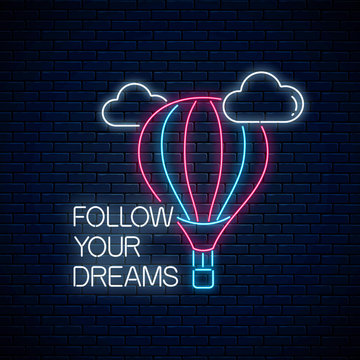 Follow your dreams - glowing neon inscription phrase with hot air balloon sign. Motivation quote in neon style.