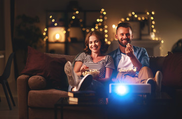 Wall Mural - Family couple watching television at home on sofa