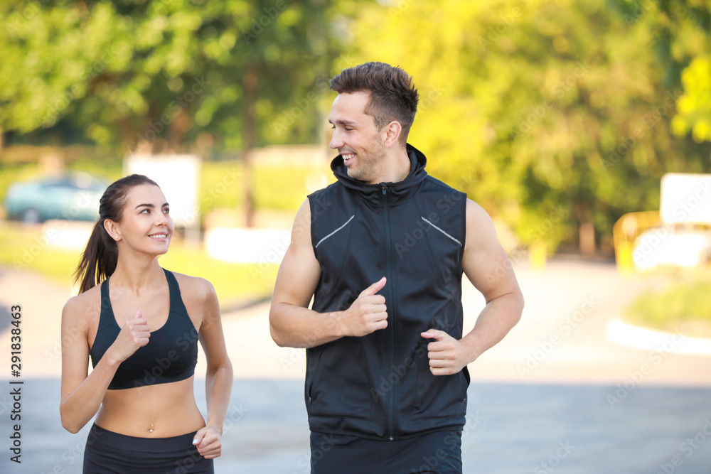 Sporty young couple running outdoors