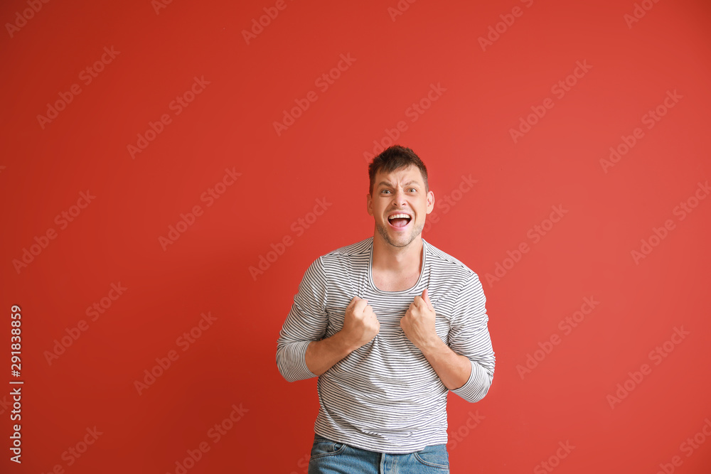 Portrait of angry man on color background