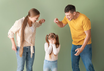 Poster - Angry parents scolding their little daughter on color background