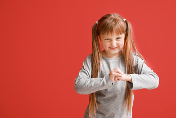 Wall Mural - Portrait of angry little girl on color background