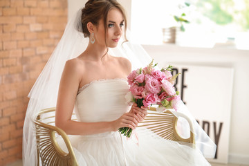 Wall Mural - Beautiful young bride with bouquet before wedding ceremony at home