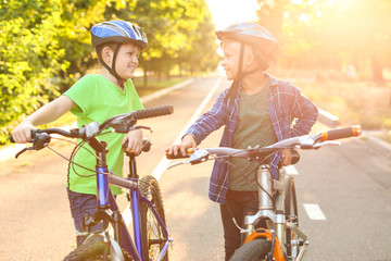 Canvas Print - Cute children riding bicycles outdoors